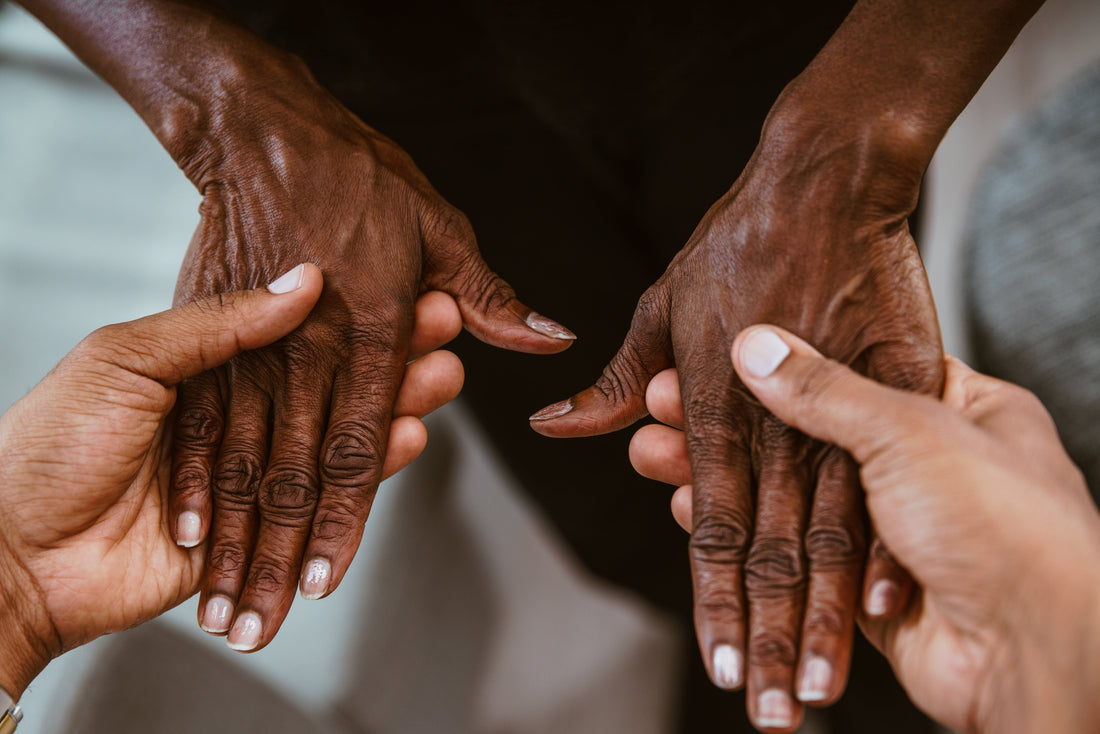 Caregiver holding an older person's hands